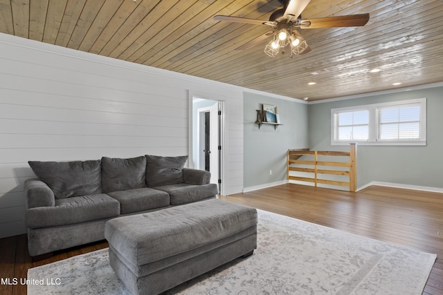 living area with a ceiling fan, wooden ceiling, wood finished floors, and baseboards