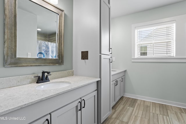 bathroom with vanity and baseboards