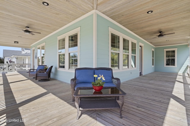 wooden terrace featuring covered porch and ceiling fan