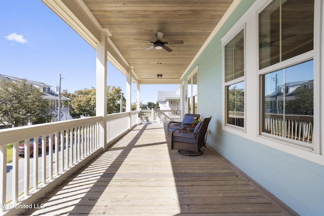 wooden terrace with a ceiling fan