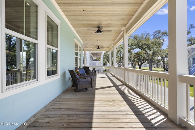 wooden terrace with a porch and ceiling fan