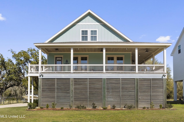 view of front facade with board and batten siding and a front yard