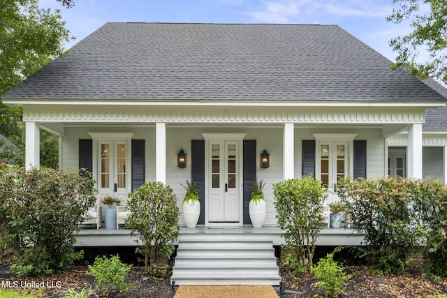 view of front of house with a shingled roof and a porch