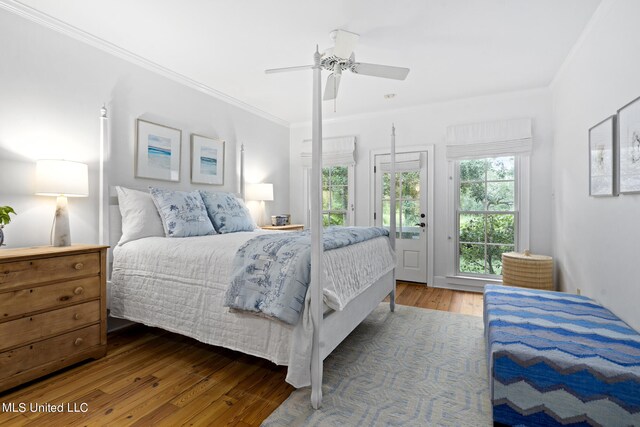 bedroom with access to outside, wood finished floors, a ceiling fan, and crown molding