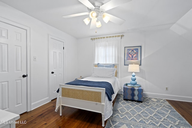 bedroom with ceiling fan, baseboards, and wood finished floors