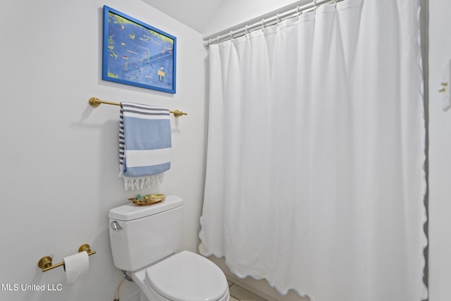 full bath featuring vaulted ceiling, curtained shower, and toilet