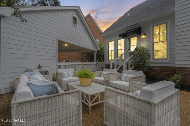 patio terrace at dusk with outdoor lounge area and fence