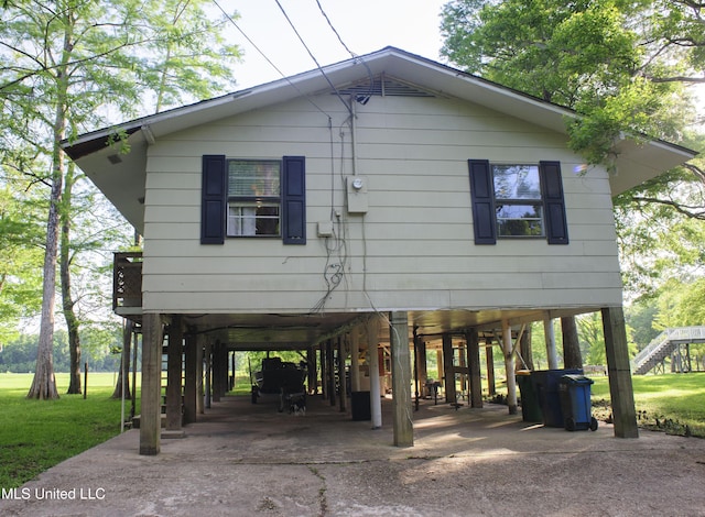 1639 Pascagoula River Rd, Moss Point, MS 39562 - view of property exterior with a carport, driveway, and stairway