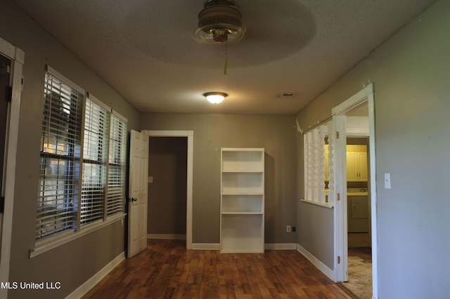 1639 Pascagoula River Rd, Moss Point, MS 39562 - hall with washer / dryer, wood finished floors, baseboards, and a textured ceiling
