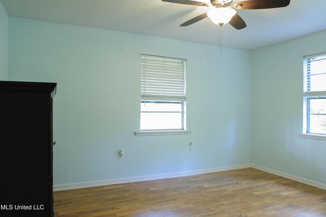 1639 Pascagoula River Rd, Moss Point, MS 39562 - empty room with wood finished floors, baseboards, and ceiling fan