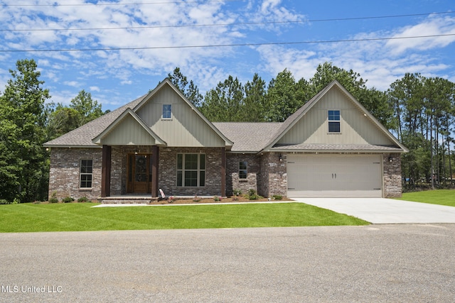 craftsman house featuring brick siding, a shingled roof, a front lawn, and driveway