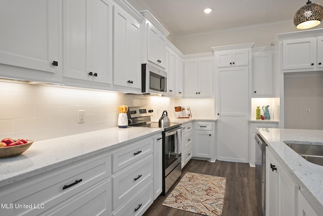 kitchen with crown molding, dark wood-style floors, white cabinetry, appliances with stainless steel finishes, and backsplash