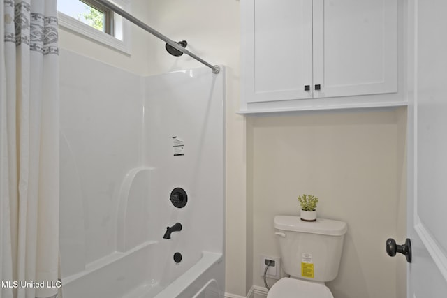 full bathroom featuring toilet and shower / bath combination with curtain
