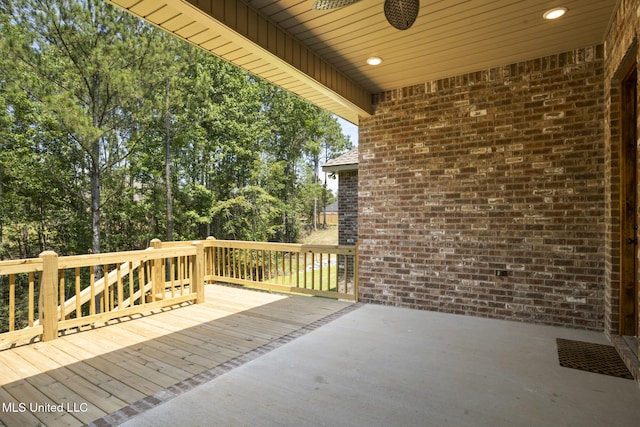 wooden deck featuring a patio and a ceiling fan