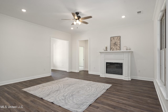 living area with ceiling fan, ornamental molding, dark wood-type flooring, and visible vents