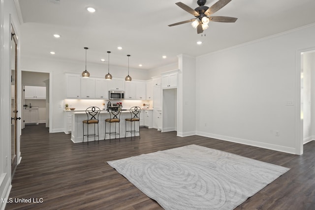 living area featuring a ceiling fan, baseboards, recessed lighting, and dark wood-type flooring