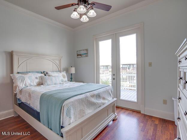 bedroom with a ceiling fan, wood finished floors, crown molding, baseboards, and access to exterior