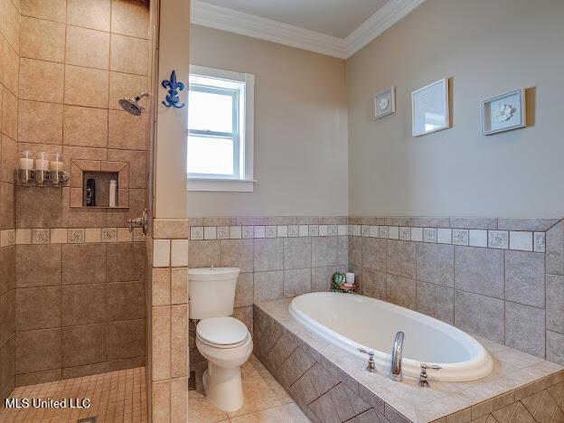 bathroom with tile patterned flooring, toilet, a garden tub, ornamental molding, and a tile shower