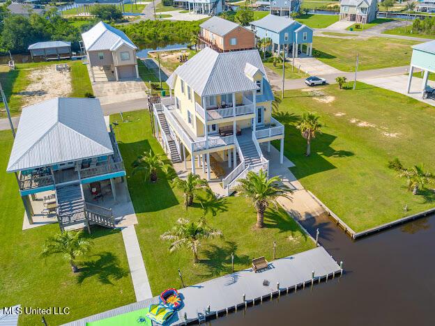 drone / aerial view featuring a residential view and a water view