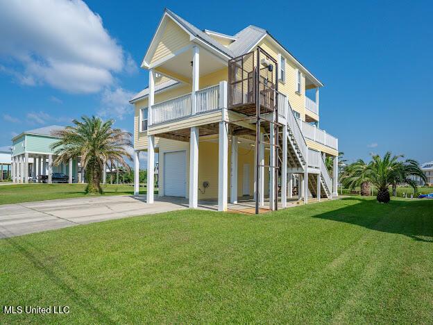 view of front of property with driveway, an attached garage, stairs, and a front yard