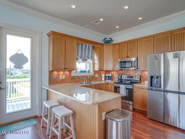 kitchen with visible vents, appliances with stainless steel finishes, dark wood-style flooring, and crown molding