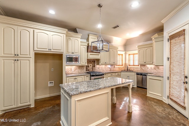 128 Amethyst Ln, Brandon, MS 39047 - kitchen featuring cream cabinets, a sink, appliances with stainless steel finishes, recessed lighting, and vaulted ceiling