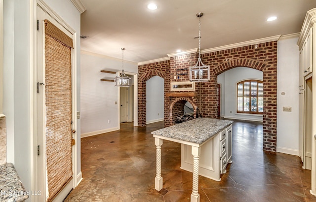 128 Amethyst Ln, Brandon, MS 39047 - kitchen featuring open floor plan, brick wall, ornamental molding, cream cabinetry, and a fireplace