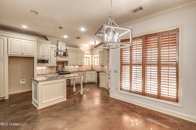 128 Amethyst Ln, Brandon, MS 39047 - kitchen featuring stainless steel appliances, a chandelier, a kitchen island, backsplash, and a sink