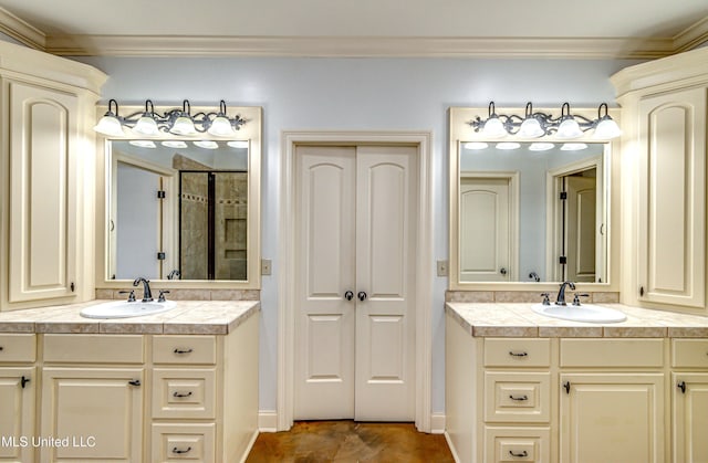 128 Amethyst Ln, Brandon, MS 39047 - full bathroom with two vanities, crown molding, a tile shower, and baseboards