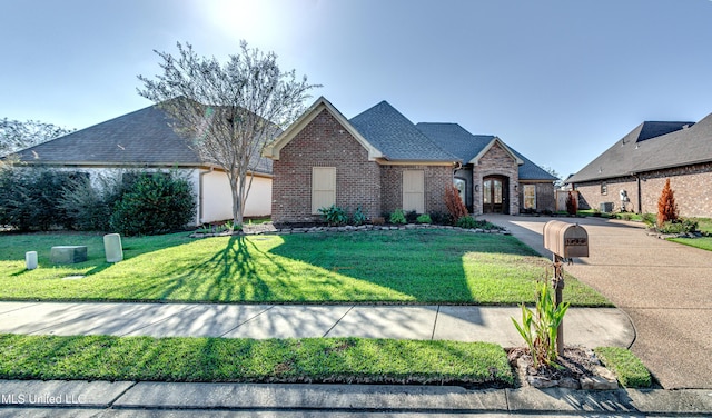 128 Amethyst Ln, Brandon, MS 39047 - french country inspired facade featuring brick siding, a front yard, and a shingled roof