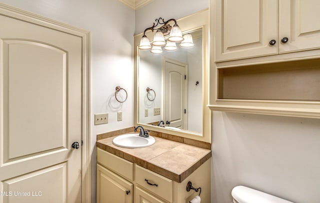 128 Amethyst Ln, Brandon, MS 39047 - bathroom with vanity, toilet, and ornamental molding