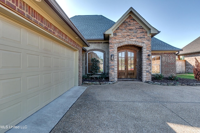 128 Amethyst Ln, Brandon, MS 39047 - doorway to property featuring roof with shingles, driveway, a garage, and stone siding