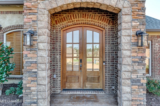 128 Amethyst Ln, Brandon, MS 39047 - property entrance featuring french doors, brick siding, stone siding, and roof with shingles