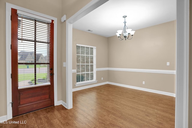 4813 Rosepetal Cv, Southaven, MS 38672 - entrance foyer with an inviting chandelier, baseboards, wood finished floors, and visible vents