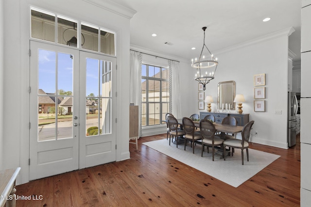 dining room with crown molding, french doors, and wood finished floors