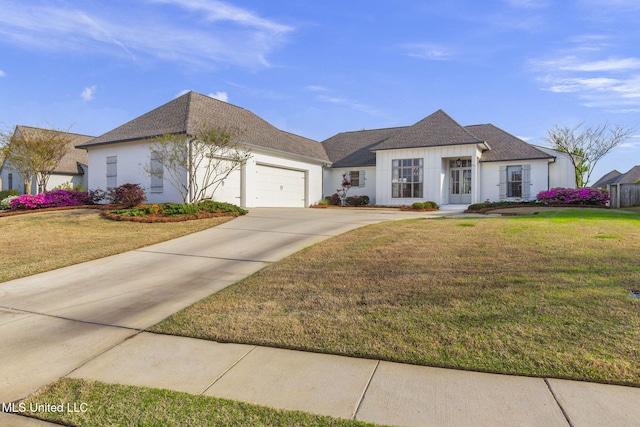 view of front of home featuring a garage, a front lawn, roof with shingles, and driveway