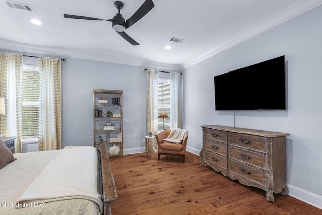 bedroom with visible vents, baseboards, crown molding, and multiple windows