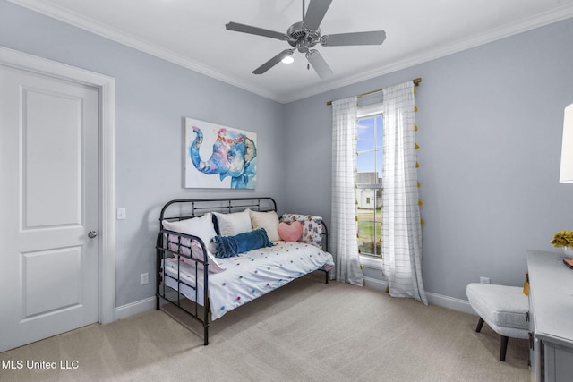 carpeted bedroom with baseboards, ornamental molding, and a ceiling fan