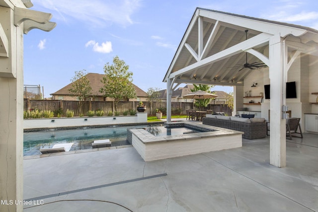 view of pool featuring ceiling fan, a fenced backyard, an outdoor hangout area, exterior kitchen, and a gazebo