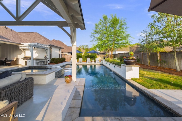 view of swimming pool with a fenced backyard, a fenced in pool, exterior kitchen, and a patio