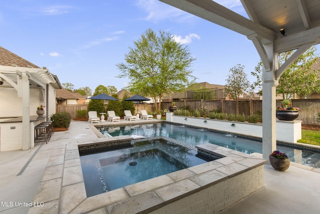 view of swimming pool with a patio, a pool with connected hot tub, and a fenced backyard