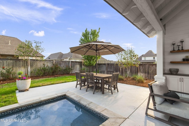 exterior space with a fenced in pool, a fenced backyard, and a patio area