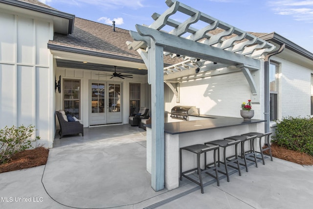 view of patio with an outdoor kitchen, a pergola, outdoor wet bar, and a grill