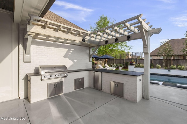 view of patio / terrace with grilling area, exterior kitchen, fence, and a pergola