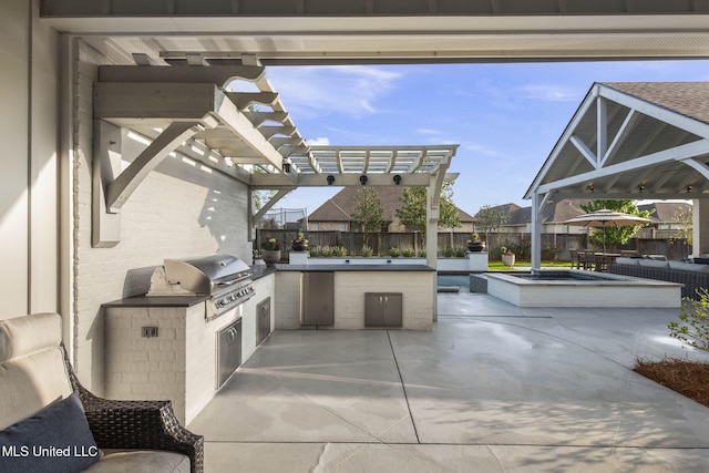 view of patio / terrace featuring an outdoor kitchen, a pergola, a fenced backyard, and area for grilling