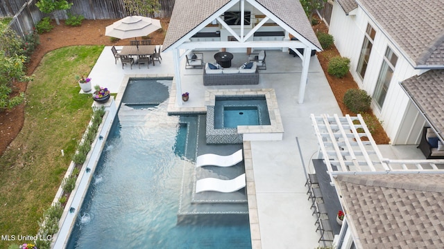 view of pool with outdoor dining area, a fenced backyard, a fenced in pool, a patio area, and an in ground hot tub