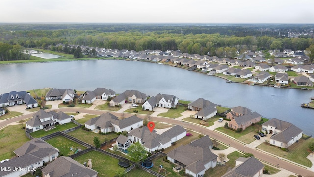 drone / aerial view featuring a water view and a residential view