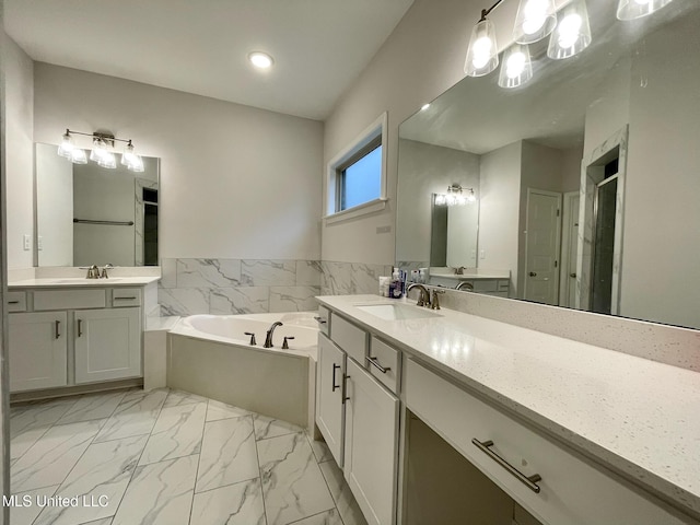 bathroom featuring shower with separate bathtub and vanity