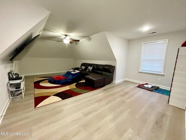 interior space with ceiling fan, lofted ceiling, and light wood-type flooring