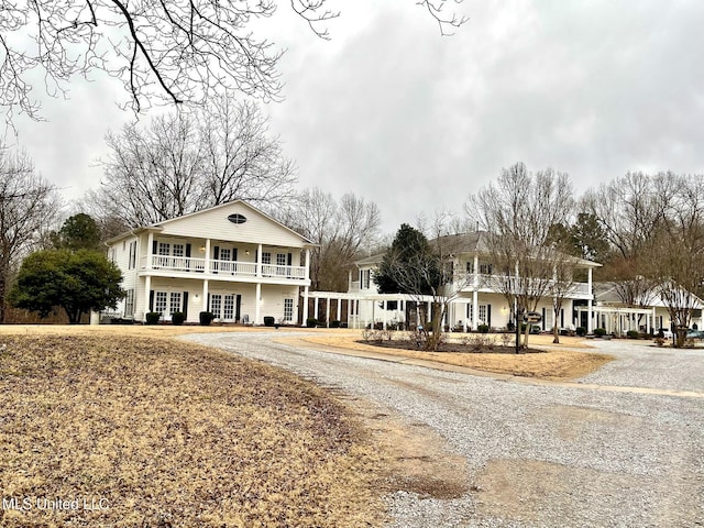 view of front of home featuring french doors and a balcony